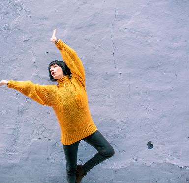 a woman poses against a wall