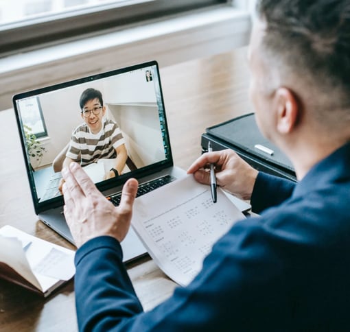 A man talking over a video call on a laptop