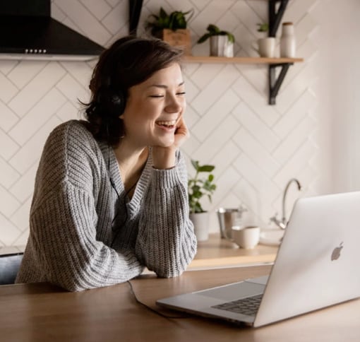 Woman talking via video call on laptop